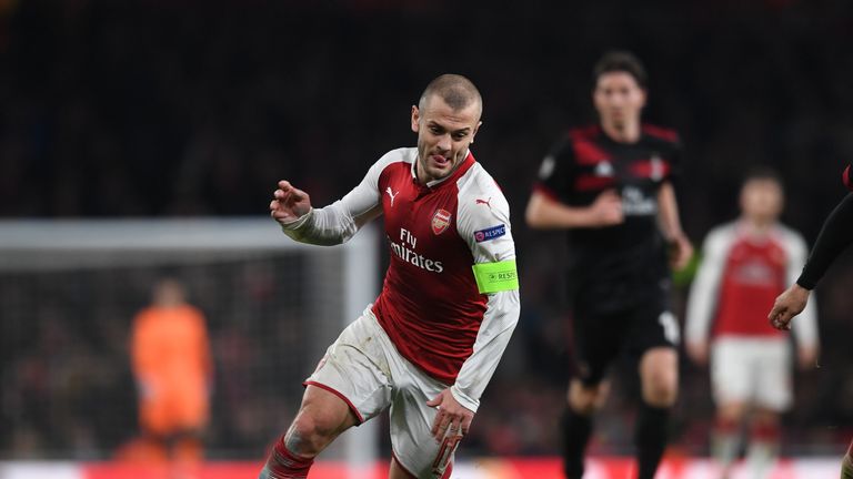 Jack Wilshere drives forward for Arsenal against AC Milan
