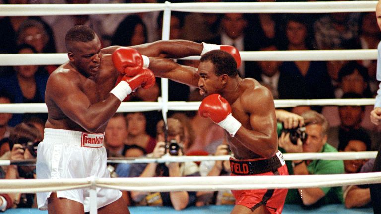 Holyfield (R) stopped Douglas to create history in 1990