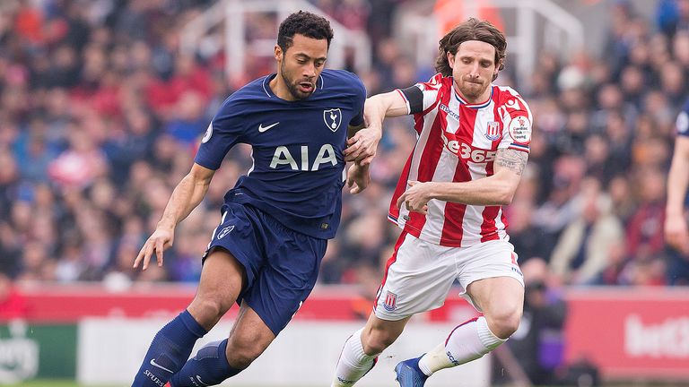 Mousa Dembele and Joe Allen in action during the first half