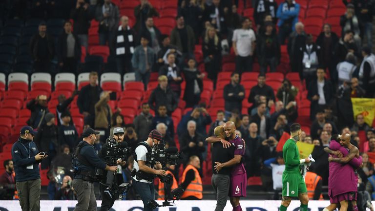 Kompany embraces manager Pep Guardiola after victory over Spurs