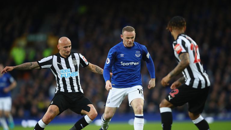 Wayne Rooney takes on Jonjo Shelvey in the first half
