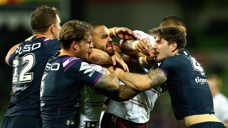 Curtis Scott of the Melbourne Storm and Manly Sea Eagles' Dylan Walker wrestle during the round 11 NRL match