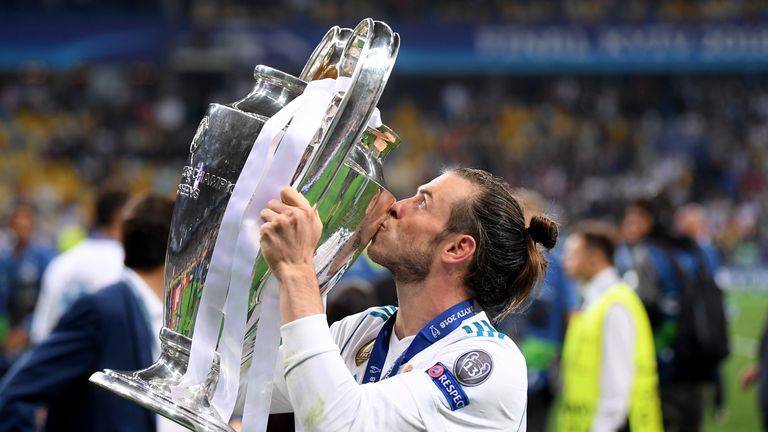 Gareth Bale kisses the Champions League trophy after helping Real Madrid seal their third consecutive title