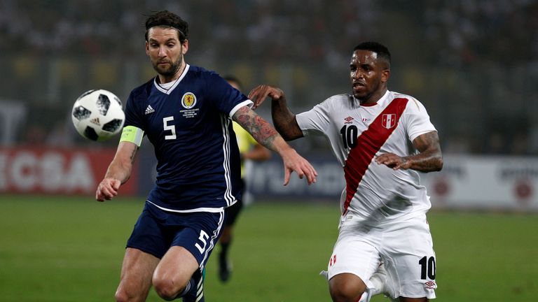Goalscorer Jefferson Farfan goes up against Charlie Mulgrew during the game