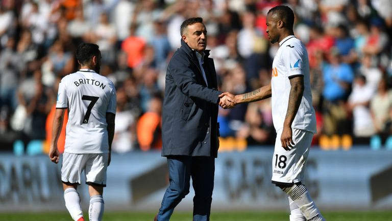 Jordan Ayew and Carlos Carvalhal shake hands at the final whistle as Swansea City are relegated