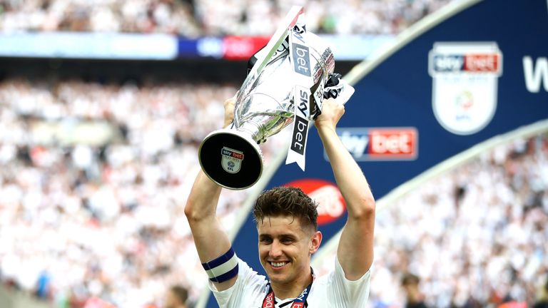 Match-winner Tom Cairney lifts the Championship play-off trophy