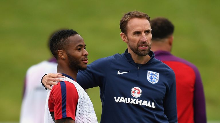 England manager Gareth Southgate with Sterling during training