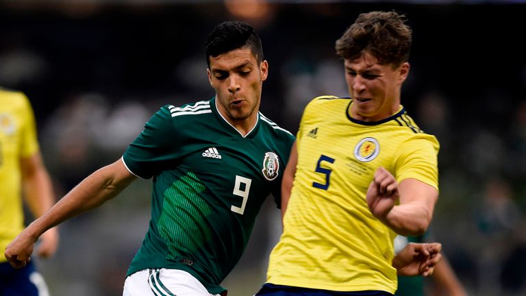 Jack Hendry (R) looks to win the ball