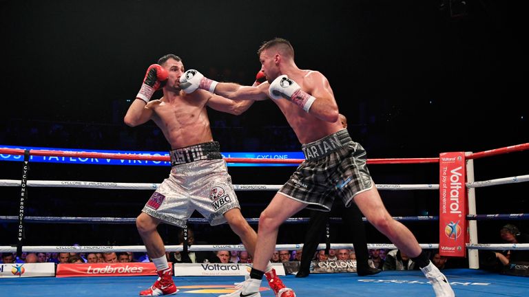 Josh Taylor (right) lands a blow on Viktor Postol in Glasgow
