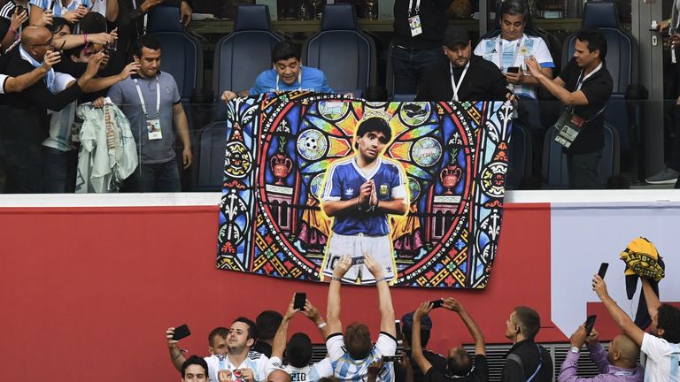 Maradona holds a flag of himself before kick off