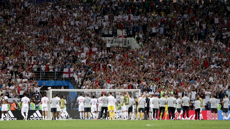 England players and staff salute the travelling fans in Moscow