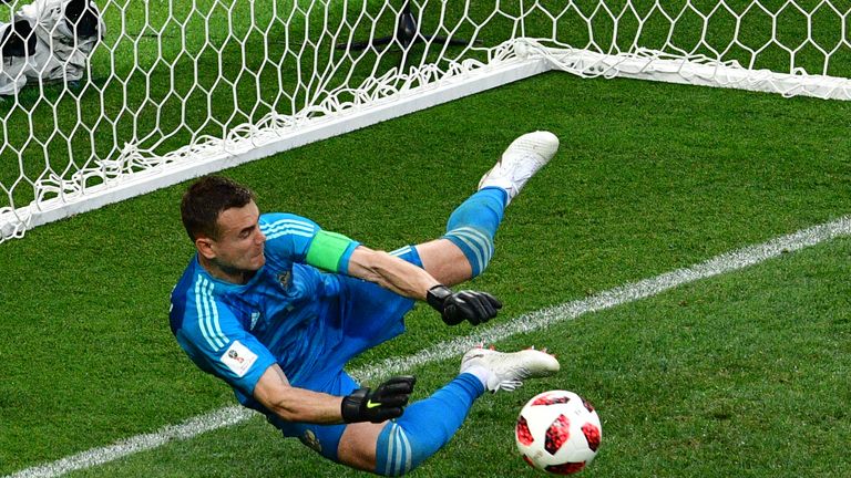 Igor Akinfeev saves a penalty for Russia against Spain in their World Cup last-16 clash