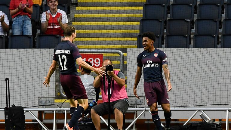 Reiss Nelson celebrates after scoring against Lazio