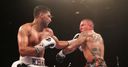 Khan climbs off canvas to beat Vargas