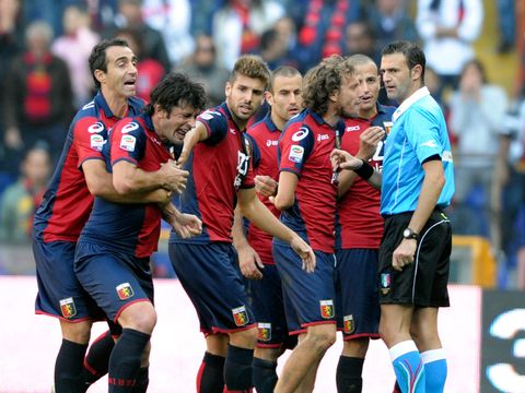Image of Kakha Kaladze: The defender is restrained by his team-mates after being sent off