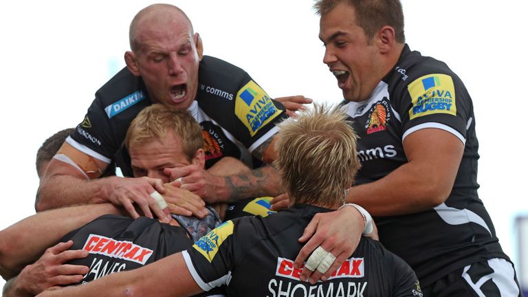 Exeter Chiefs players celebrate with tryscorer Tom James