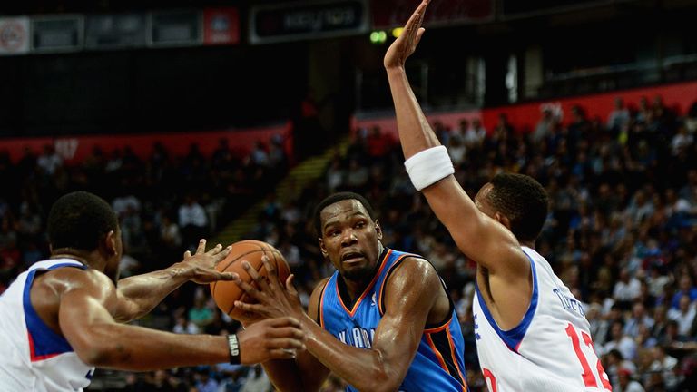 Kevin Durant (in blue) on the charge in Manchester