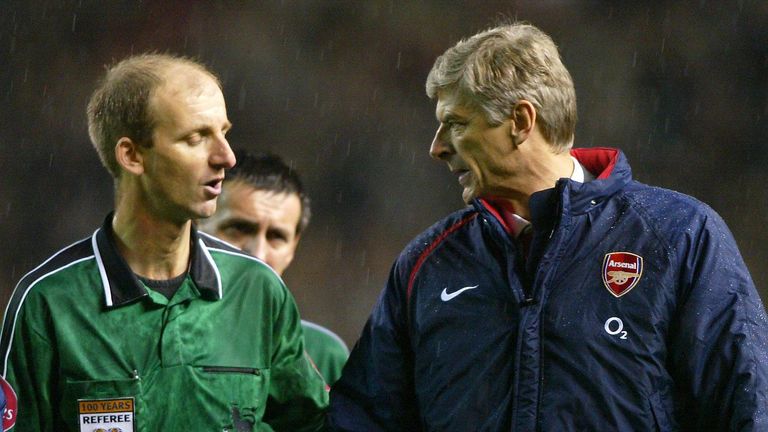 Arsenal manager Arsene Wenger has a word with match referee Riley
