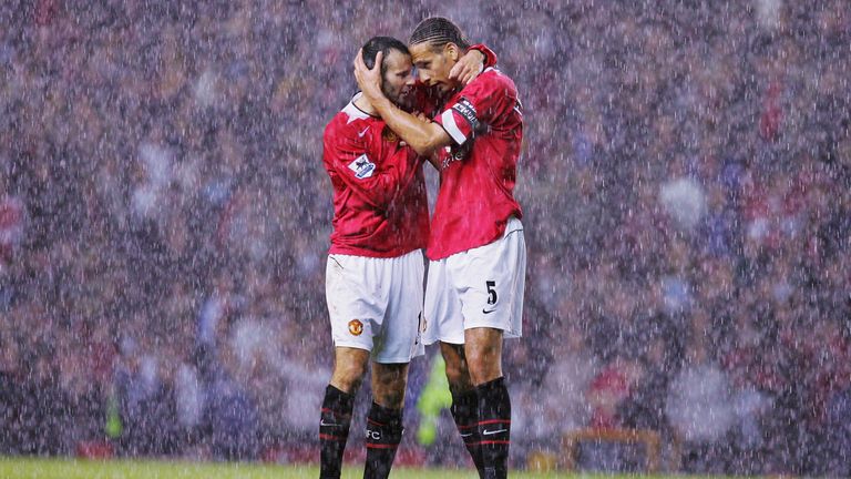 Ryan Giggs and Rio Ferdinand celebrate in the rain after the final whistle