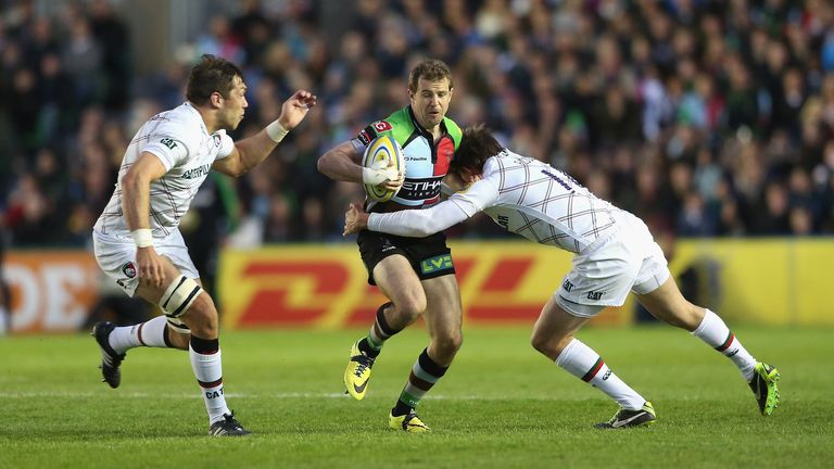 Nick Evans of Harlequins is tackled by Leicester&#39;s Toby Flood