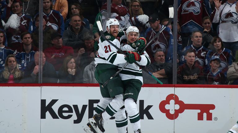 Nino Niederreiter is congratulatd by Kyle Brodziak after his winning strike