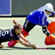 Close contest: Belgium's Stephanie de Groof (l) and England's Maddie Hinch vie for the ball