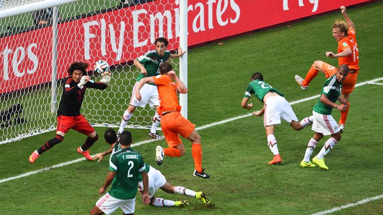 Guillermo Ochoa saves from Stefan de Vrij