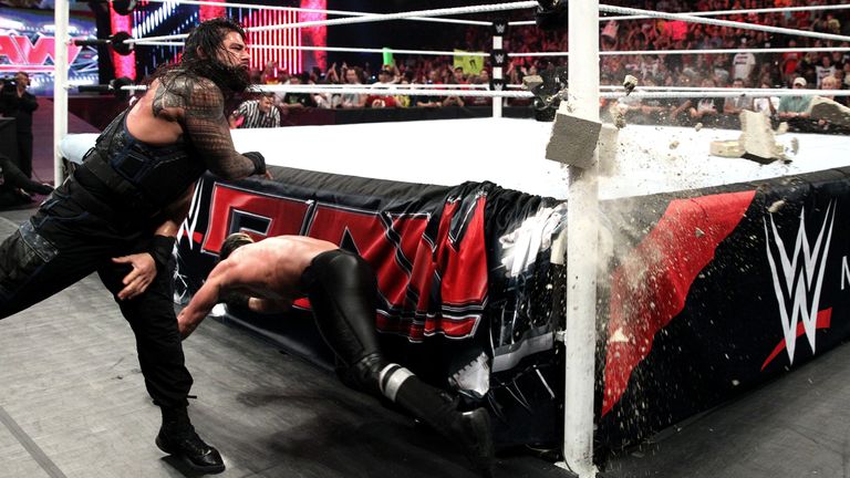Roman Reigns narrowly misses hitting Seth Rollins with a cinderblock