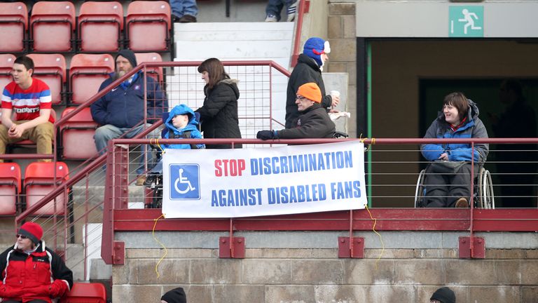 Disabled fans at a Scottish Premier League match express their feelings with a banner