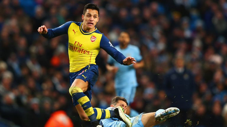Alexis Sanchez jumps a tackle from Martin Demichelis