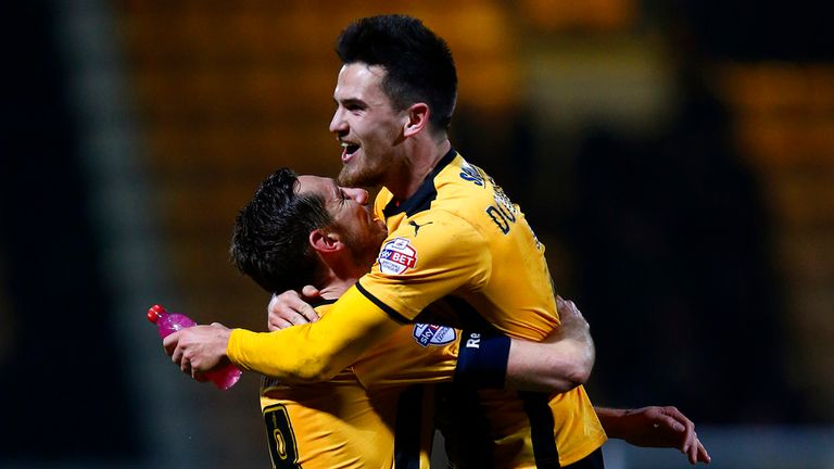 Ryan Donaldson of Cambridge United celebrates with team-mate Tom Champion.