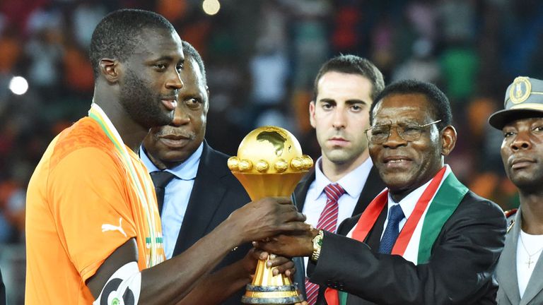 Yaya Toure receives the Africa Cup of Nations after Ivory Coast beat Ghana on penalties