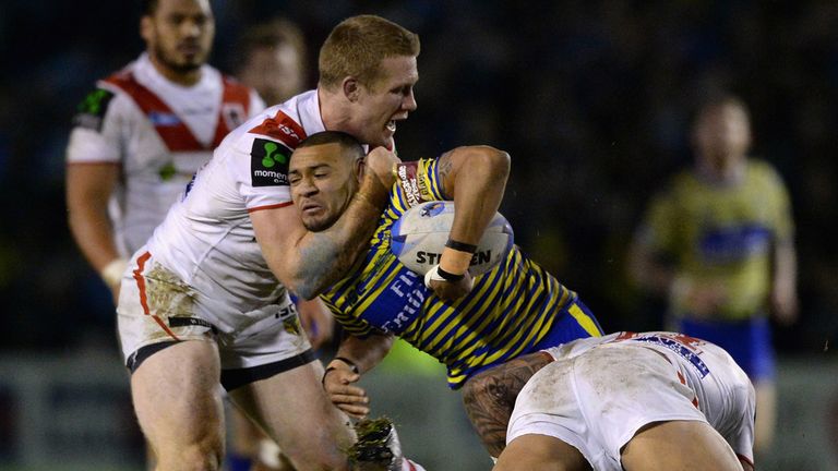 Warrington's Kevin Penny is tackled by Ben Creagh and Josh Dugan