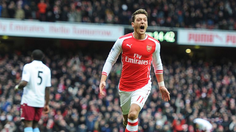 Mesut Ozil celebrates scoring against Aston Villa last season