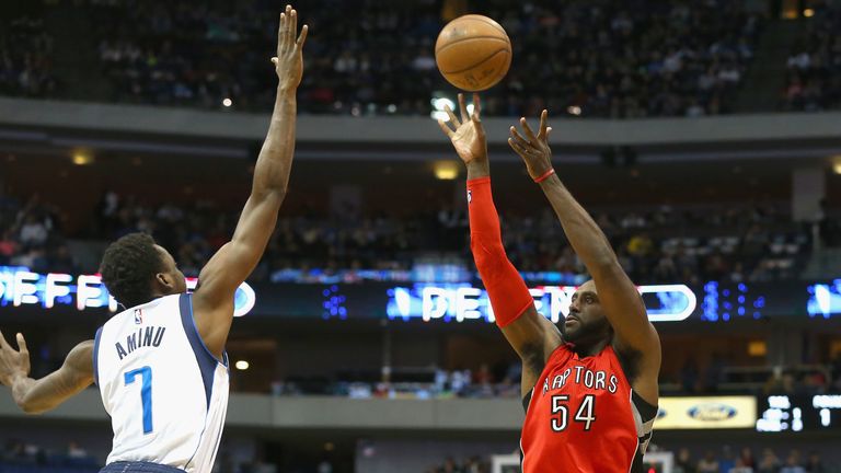 Patrick Patterson #54 of the Toronto Raptors takes a shot against Al-Farouq Aminu #7 of the Dallas Mavericks at American Airlines Center 
