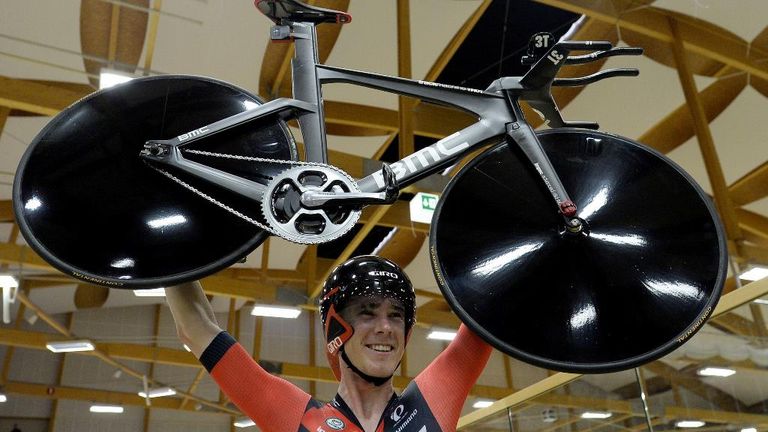Rohan Dennis celebrated breaking the hour record by lifting his bike above his head