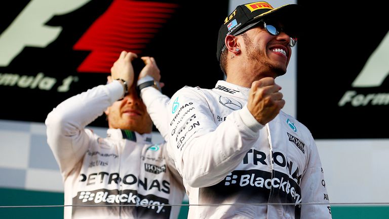 Lewis Hamilton: Celebrates his win on the podium next to Nico Rosberg
