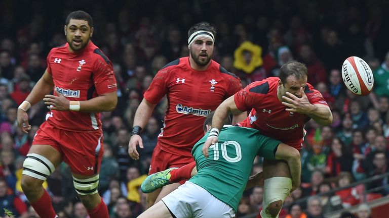 Jamie Roberts (R) loses the ball as he is tackled by Johnny Sexton
