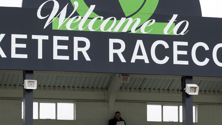 A racing fan sits in one of the stands at Uttoxeter Racecourse