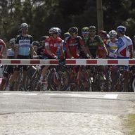 Paris-Roubaix riders are halted at a rail crossing