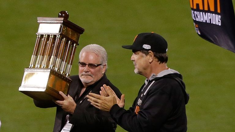General manager Brian Sabean and manager Bruce Bochy hold up the San Francisco Giants' Warren C. Giles Trophy 