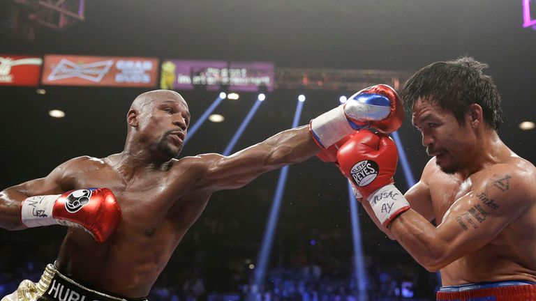 Floyd Mayweather Jr (left) trades blows with Pacquiao in their superfight in May