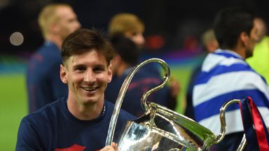 Lionel Messi celebrates with the trophy after winning the Champions League again