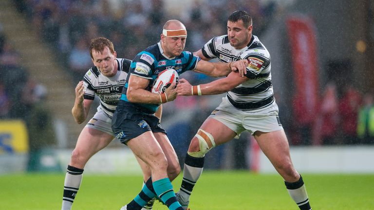 Carl Ablett is tackled by Hull duo Jordan Thompson and Josh Bowden