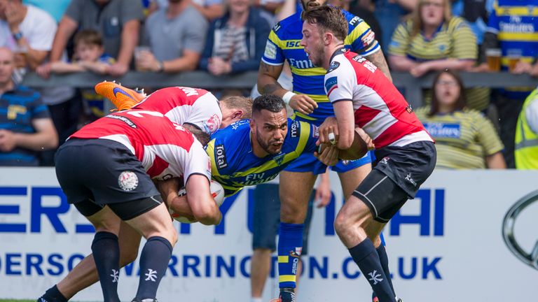 Warrington's Ryan Atkins is held up by Greg Worthington, Andrew Dixon and Ryan Brierley