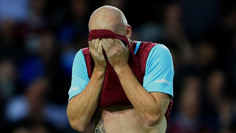 West Ham's James Collins leaves the field dejected after being sent off.