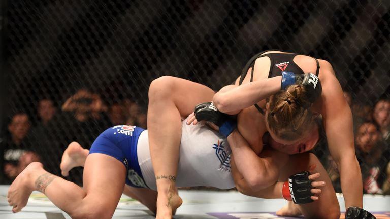 Rousey (top) submitted Zingano in record-breaking fashion