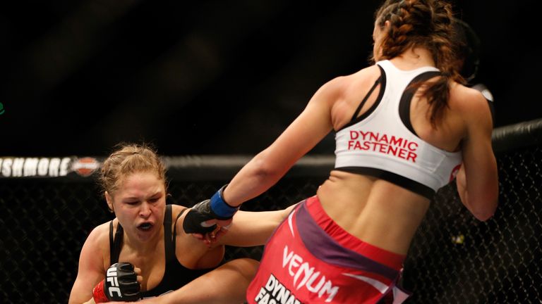 Rousey counters a kick from Tate