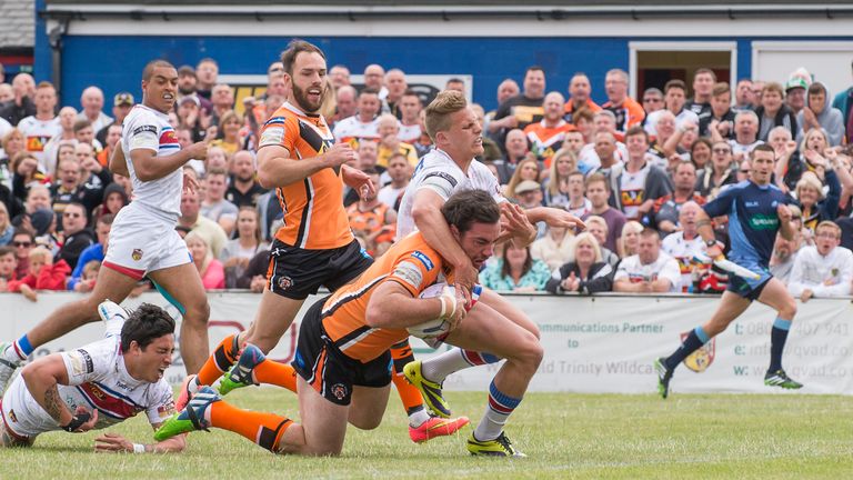 Kevin Locke (bottom left) suffers a shoulder injury while trying to prevent Castleford's Grant Millington from scoring a try