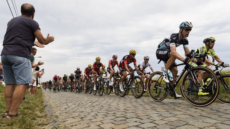 Tony Martin leads the peloton across the cobbles on stage four